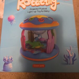 Ocean Park Rotating Projector Musical Light-Up Toy - Pink & Blue